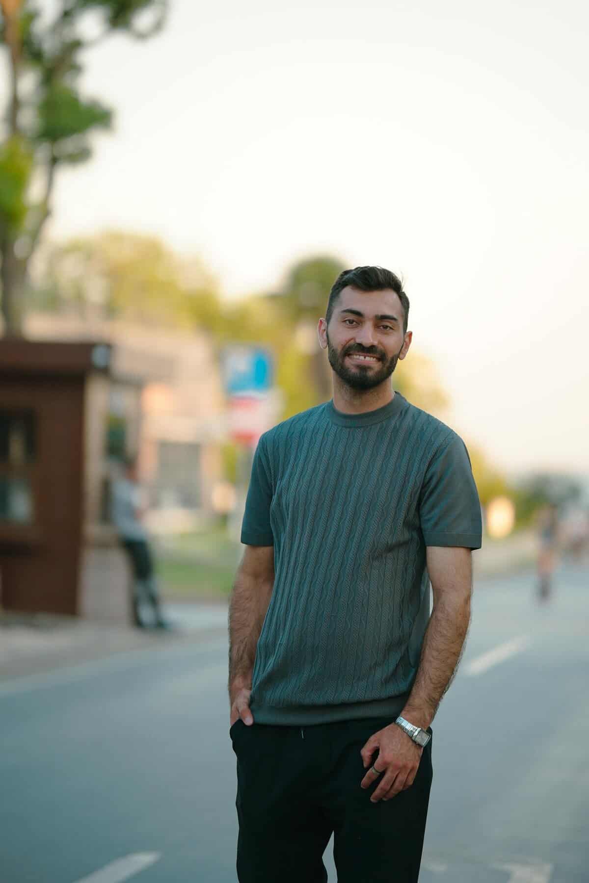 Man standing in the street and smiling